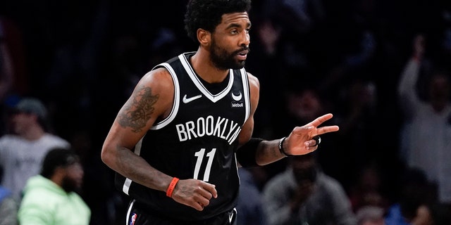 The Brooklyn Nets' Kyrie Irving reacts after scoring a basket against the Cleveland Cavaliers during the first half of the opening game of the NBA Play-In April 12, 2022, in New York.