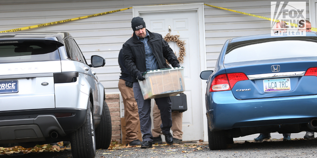 Investigators search a home in Moscow, Idaho, on Monday, Nov. 14, 2022, where four University of Idaho students were killed over the weekend.