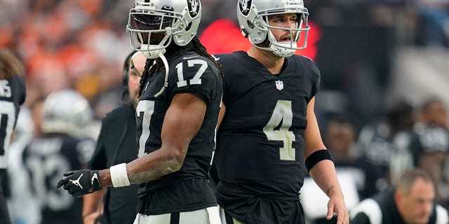 Raiders wide receiver Davante Adams, left, and quarterback Derek Carr on the sidelines during the Denver Broncos game, Oct. 2, 2022, in Las Vegas.