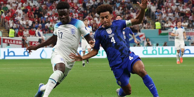 Bukayo Saka of England vies with Tyler Adams of the U.S. during their FIFA World Cup Qatar 2022 Group B match at Al Bayt Stadium in Al Khor, Qatar, on Friday.