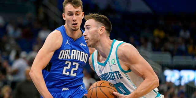 Charlotte Hornets' Gordon Hayward, right, moves to the basket against Orlando Magic's Franz Wagner (22) during the first half of an NBA basketball game, Wednesday, Oct. 27, 2021, in Orlando, Fla.