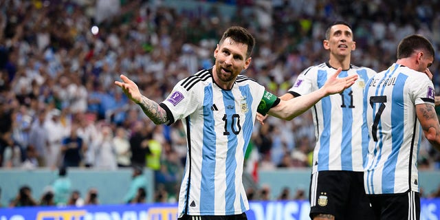 Lionel Messi of Argentinia (L) celebrates after scoring his team's first goal with Angel Di Maria (C) and Rodrigo De Paul (R) during the FIFA World Cup Qatar 2022 Group C match between Argentina and Mexico at Lusail Stadium on November 26, 2022 in Lusail City, Qatar. 