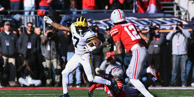 Donovan Edwards #7 of the Michigan Wolverines evades a tackle during the second quarter of a game against the Ohio State Buckeyes at Ohio Stadium on November 26, 2022 in Columbus, Ohio. 