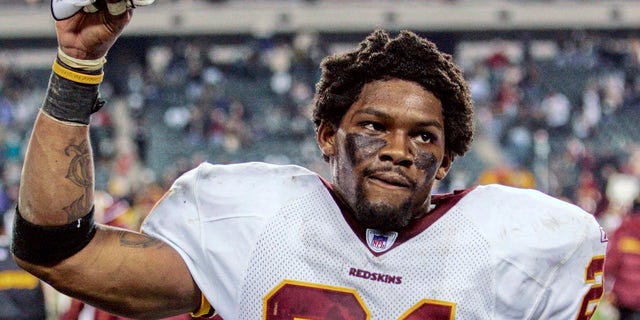 Washington Redskins safety Sean Taylor raises his hand to acknowledge fans after the Redskins defeated the Philadelphia Eagles in Philadelphia in this Jan. 1, 2006, file photo. 