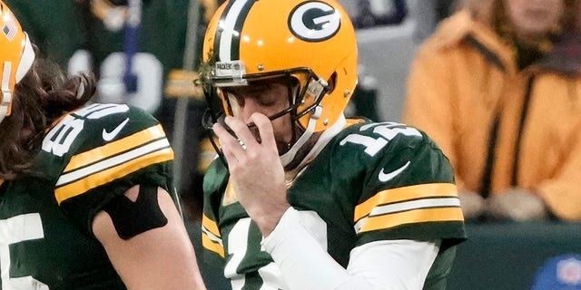 Green Bay Packers' Aaron Rodgers (12), Robert Tonyan (85) and Aaron Jones (33) walk off the field after Rodgers fumbled the ball while being sacked during the first half of an NFL football game against the Dallas Cowboys Sunday, Nov. 13, 2022, in Green Bay, Wis.