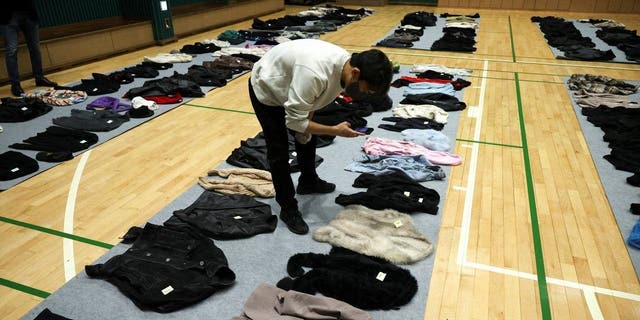 Belongings of victims are photographed at a gym, where recovered belongings of the victims of a crowd crush that happened during Halloween festivities are kept, in Seoul, South Korea, Nov. 1, 2022. 