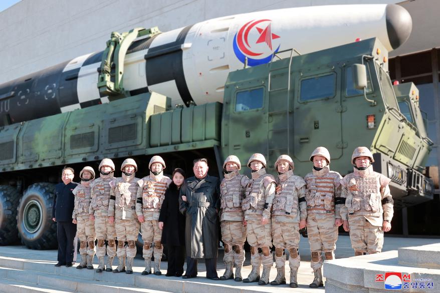 Kim Jong Un with his daughter in front of the Hwasong-17 intercontinental ballistic missile.