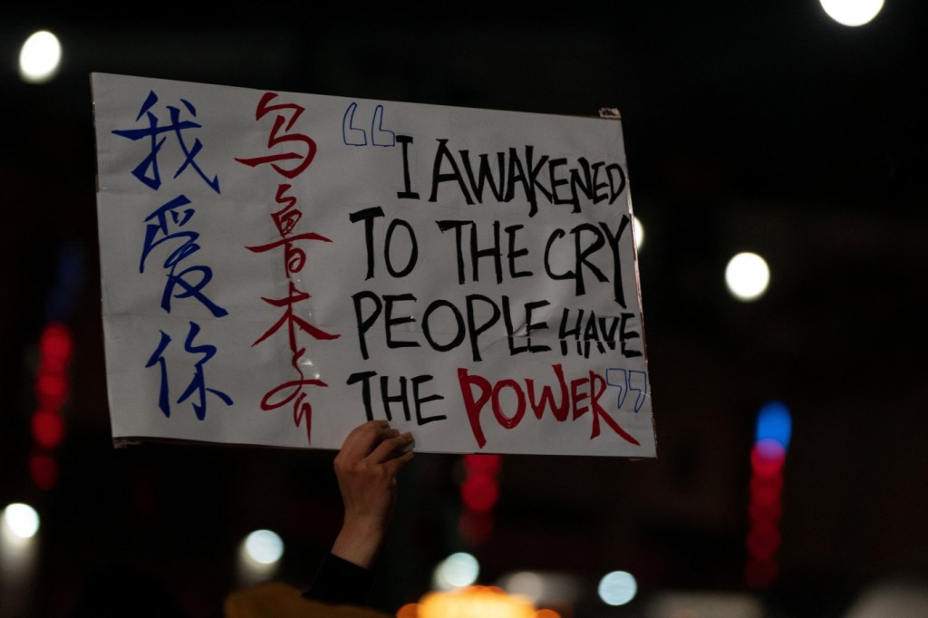 A person holds up a placard while taking part in anti-Chinese government protests near the Chinese consulate in New York City on Nov. 29, 2022.   