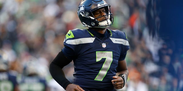 Geno Smith of the Seattle Seahawks jogs across the field in the third quarter against the Las Vegas Raiders at Lumen Field on Nov. 27, 2022, in Seattle, Washington.