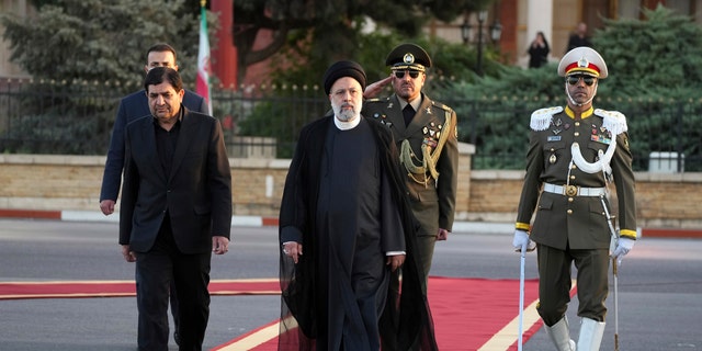 Iranian President Ebrahim Raisi, center, reviews an honor guard during his official departure ceremony, Sept. 19, 2022, as he leaves Tehran's Mehrabad International Airport to attend the annual U.N. General Assembly meeting.