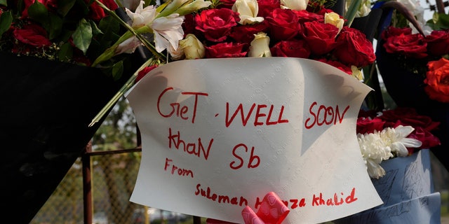 A bouquet with a "get well soon" message is placed by well-wisher over the wall of a hospital where former Pakistani Prime Minister Imran Khan is being treated for a gunshot wound in Lahore, Pakistan, Friday, Nov. 4, 2022.