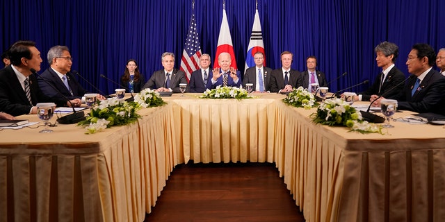 U.S. President Joe Biden meets with South Korean President Yoon Suk Yeol, left, and Japanese Prime Minister Fumio Kishida, right, on the sidelines of the Association of Southeast Asian Nations (ASEAN) summit on Nov. 13, 2022, in Phnom Penh, Cambodia. 