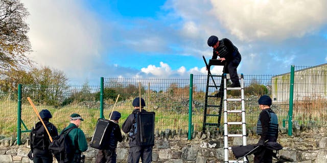 Army search teams assisted by the PSNI inspect the scene, following the attempted murder of two officers in Strabane, Northern Ireland, Friday Nov. 18, 2022. 