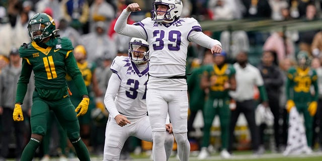 TCU place kicker Griffin Kell (39) reacts to scoring a field goal with teammate Jordy Sandy (31) as Baylor cornerback Lorando Johnson (11) looks on in the final seconds of an NCAA college football game in Waco, Texas, Saturday, Nov. 19, 2022. TCU won 29-28. 