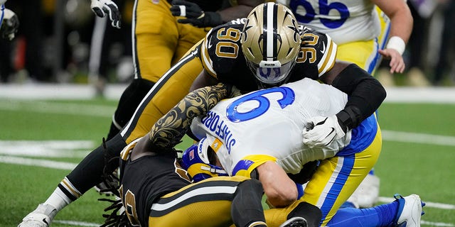 Los Angeles Rams quarterback Matthew Stafford (9) is sacked by New Orleans Saints defensive end Tanoh Kpassagnon (90) in the second half of an NFL football game in New Orleans, Sunday, Nov. 20, 2022. 