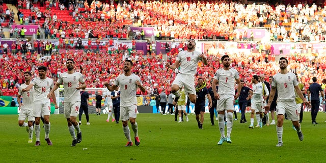 Iran's players celebrate winning the World Cup Group B soccer match against Wales at the Ahmad Bin Ali Stadium in Al Rayyan, Qatar, Friday, Nov. 25, 2022. 