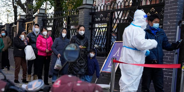 Residents line up for COVID-19 tests in Beijing, Saturday, Nov. 26, 2022. 