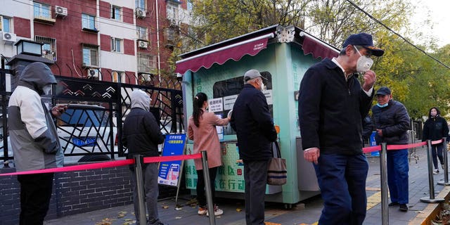 Residents line up for COVID-19 tests in Beijing, Saturday, Nov. 26, 2022.