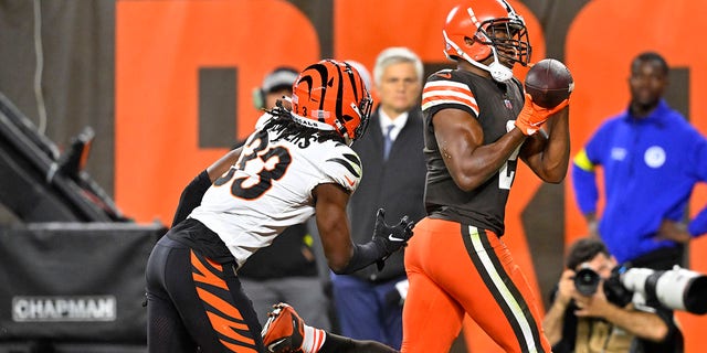 Cleveland Browns wide receiver Amari Cooper, #2, catches a pass from quarterback Jacoby Brissett for a touchdown with Cincinnati Bengals cornerback Tre Flowers, #33, defending during the second half of an NFL football game in Cleveland, Monday, Oct. 31, 2022.