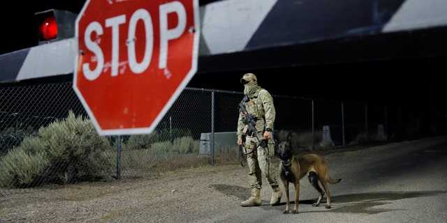 A security guard stands at an entrance to the Nevada Test and Training Range near Area 51