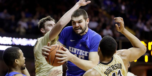 Kentucky forward Isaac Humphries, center, grabs a rebound in front of Vanderbilt's Luke Kornet, second from left, and Jeff Roberson (11) during the first half of an NCAA college basketball game on Jan. 10, 2017, in Nashville, Tenn. Melbourne United starting center Isaac Humphries has announced that he is gay and said he hopes his decision to publicly announce his sexuality will lead to more professional sportsmen doing the same.