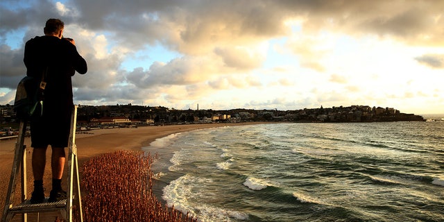 US artist and photographer Spencer Tunick created the nude installation using thousands of volunteers posing at sunrise on Bondi Beach, commissioned by charity Skin Check Champions to raise awareness of skin cancer and to coincide with National Skin Cancer Action Week.