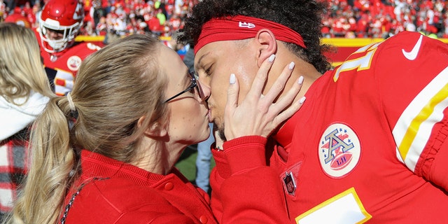 Kansas City Chiefs quarterback Patrick Mahomes kisses fiancée Brittany Matthews before an NFL game.