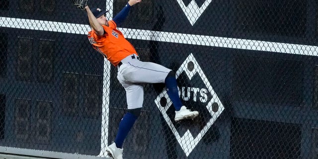 Houston Astros left fielder Chas McCormick catches a fly ball hit by Philadelphia Phillies' J.T. Realmuto during the ninth inning in Game 5 of baseball's World Series between the Houston Astros and the Philadelphia Phillies on Thursday, Nov. 3, 2022, in Philadelphia.