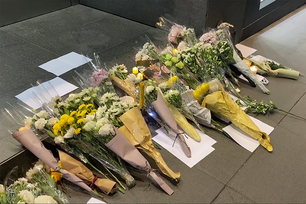 Blank white papers and flowers are laid down during a commemoration for victims of a recent Urumqi deadly fire in Central in Hong Kong, Monday, Nov. 28, 2022.