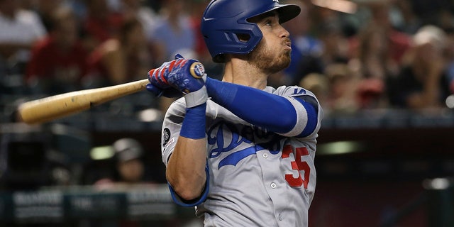 In this Sept. 1, 2019, file photo, the Los Angeles Dodgers' Cody Bellinger watches the flight of a home run against the Arizona Diamondbacks during the ninth inning of a game in Phoenix.