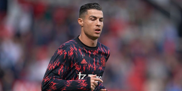 Manchester United's Cristiano Ronaldo warms up before the English Premier League soccer match between Manchester United and Norwich City at Old Trafford stadium in Manchester, England, Saturday, April 16, 2022.