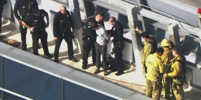 A man who climbed the side fo a downtown Los Angeles hotel was greeted by police officers when he got to the top. 