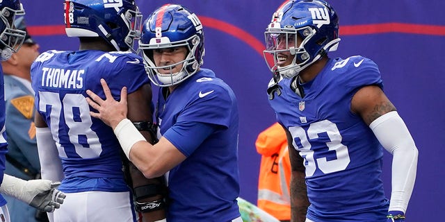 New York Giants quarterback Daniel Jones celebrates with teammates after they scored a touchdown against the Houston Texans, Sunday, Nov. 13, 2022, in East Rutherford, New Jersey.