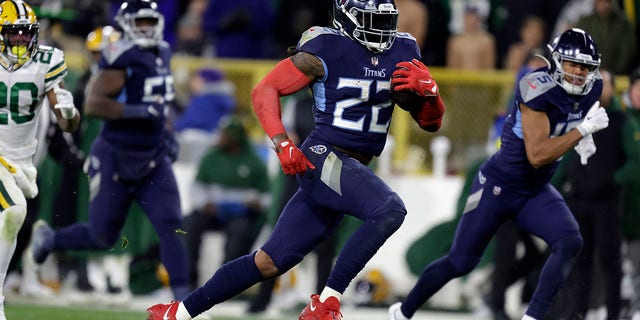 Tennessee Titans running back Derrick Henry, #22, gains long yardage after catching a pass during the second half of an NFL football game against the Green Bay Packers Thursday, Nov. 17, 2022, in Green Bay, Wisconsin.