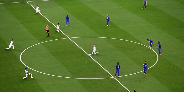 English players take a knee before kickoff during a FIFA World Cup Qatar 2022 Group B match against the U.S. at Al Bayt Stadium Nov. 25, 2022, in Al Khor, Qatar.