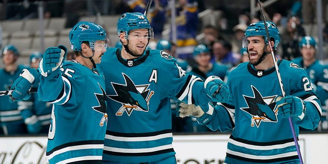 San Jose Sharks defenseman Erik Karlsson, left, is congratulated by center Tomas Hertl, middle, and defenseman Jaycob Megna after scoring a goal during the first period of an NHL hockey game against the Anaheim Ducks in San Jose, California, Tuesday, Nov. 1, 2022.