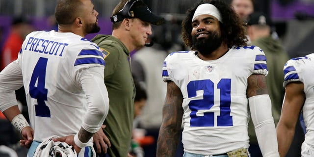 Dallas Cowboys running back Ezekiel Elliott, #21, talks with teammate quarterback Dak Prescott, #4, during the second half of an NFL football game against the Minnesota Vikings, Sunday, Nov. 20, 2022, in Minneapolis. 