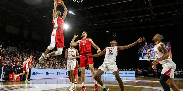 Canada's Jean-Victor Mukama dunks as teammate Owen Klassen and Panama's Eric Romero, center, look on during FIBA World Cup qualifiers action in Edmonton, Alberta, on Sunday.