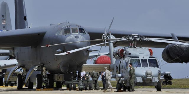 A U.S Air Force Seahawk Helicopter stands in front of a B-52 bomber on a runway on the opening day of the Australian International Airshow and Aerospace and Defence Expo in Melbourne March 1, 2011. 