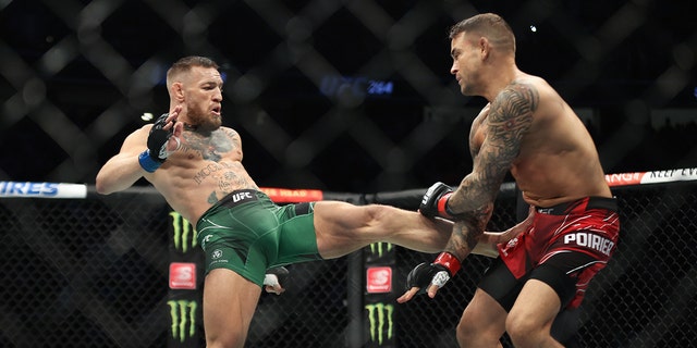 Conor McGregor, left, and Dustin Poirier in their lightweight fight during UFC 264 at T-Mobile Arena in Las Vegas, July 10, 2021.