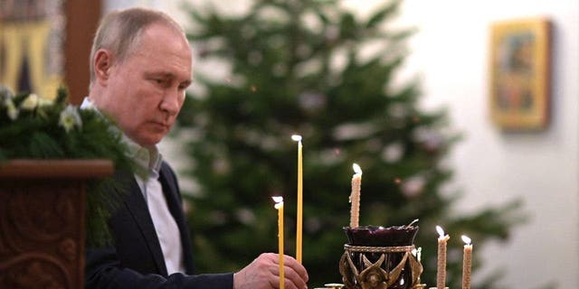 Russian President Vladimir Putin attends an Orthodox Christmas Mass in a church at the Novo-Ogaryovo state residence near Moscow Jan. 7, 2022. 