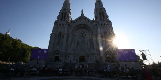 Catholic faithful await Pope Francis at the National Shrine of Sainte-Anne-de-Beaupré in Quebec, Canada.