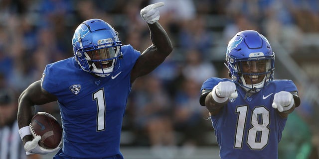 Buffalo Bulls wide receiver Justin Marshall, #1, and wide receiver Jamari Gassett, #18, celebrate a touchdown catch by Marshall during the first quarter of a college football game between the Holy Cross Crusaders and the Buffalo Bulls on September 10, 2022, at UB Stadium in Amherst, New York.