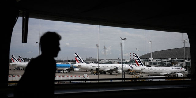 A traveler walks in the Terminal 2 corridors of the Roissy-Charles de Gaulle airport, in the northeastern outskirts of Paris, on September 16, 2022. 