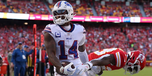 Buffalo Bills wide receiver Stefon Diggs (14) hauls in a 17-yard touchdown catch over Kansas City Chiefs cornerback Joshua Williams (23) in the third quarter of a game Oct. 16, 2022, at GEHA Field at Arrowhead Stadium in Kansas City, Mo. 