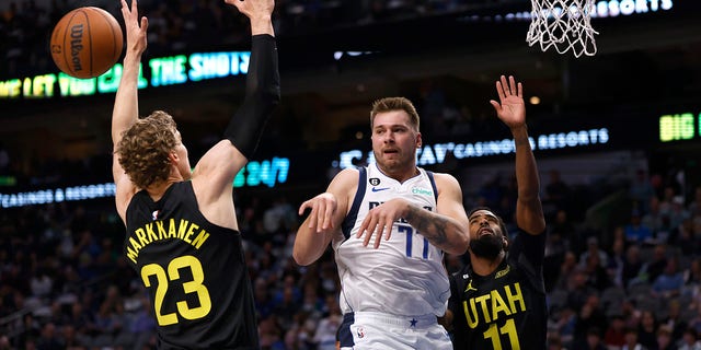 Luka Doncic, #77 of the Dallas Mavericks, passes over Lauri Markkanen, #23 of the Utah Jazz, in the first half at American Airlines Center on Nov.r 2, 2022 in Dallas.