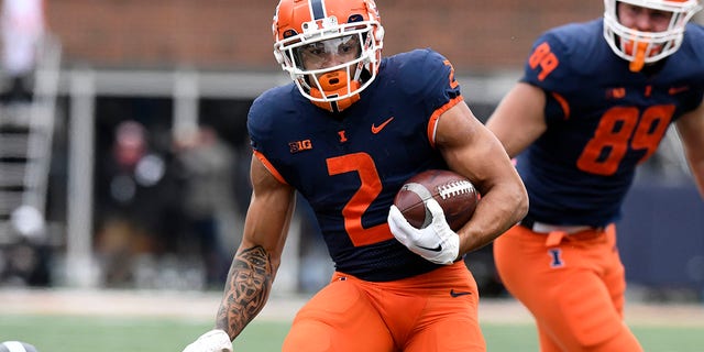 Illinois Fighting Illini running back Chase Brown (2) advances the ball during a game against the Purdue Boilermakers Nov. 12, 2022, at Memorial Stadium in Champaign, Ill. 