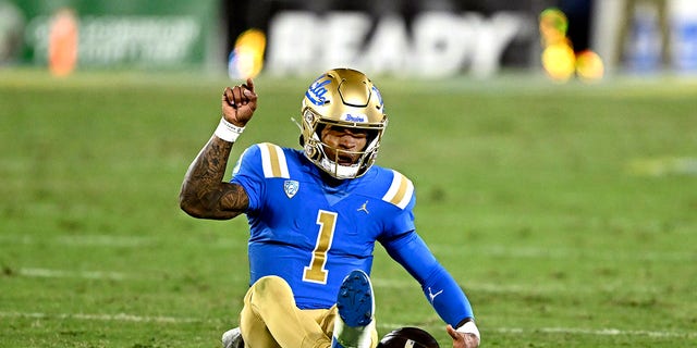 Quarterback Dorian Thompson-Robinson of the UCLA Bruins points toward the end zone against the Arizona Wildcats in the first half of a game at the Rose Bowl in Pasadena Nov. 12, 2022. 