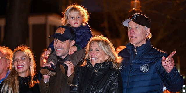 US President Joe Biden watches a Christmas tree lighting ceremony with (R-L) First Lady Jill Biden, son Hunter Biden, grandson Beau, and daughter-in-law Melissa Cohen in Nantucket, Massachusetts, on November 25, 2022.