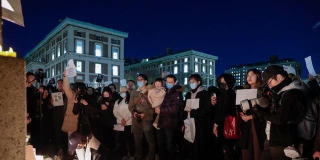 People gather at Columbia University during a protest in support of demonstrations held in China calling for an end to COVID-19 lockdowns.